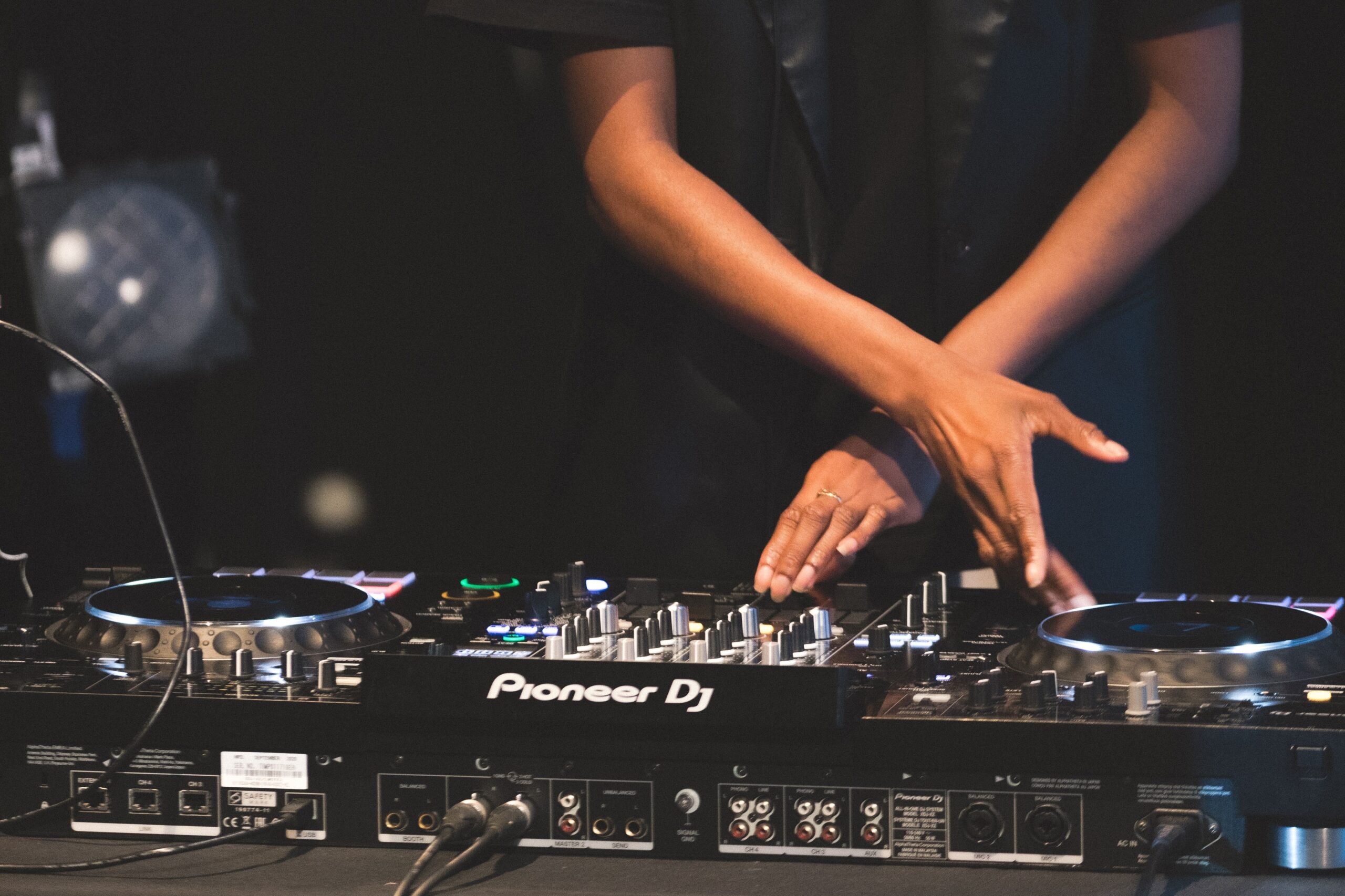 Hands mixing on a Pioneer DJ deck